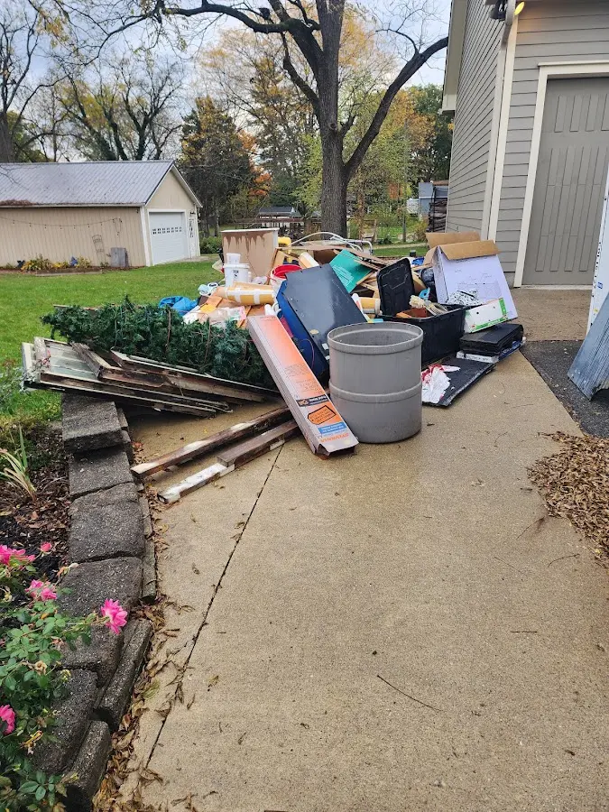 Dumpster being loaded with debris for Roofing Dumpster Rental in Glocester